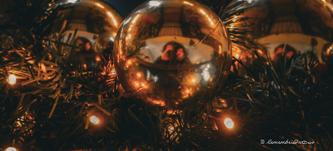 3 large golden baubles on a Christmas tree