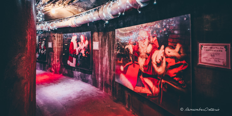 The pictures of Santa Claus is on the wall of the tunnel at Casa Loma.