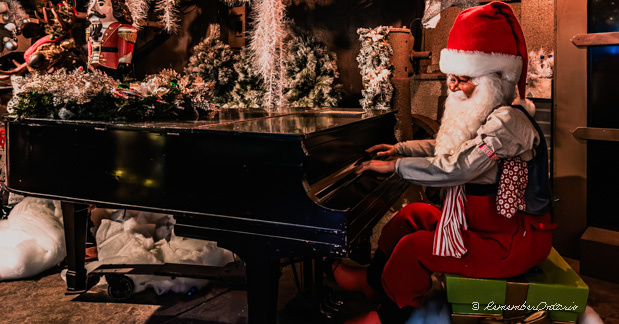 Santa Claus is playing a grand piano.