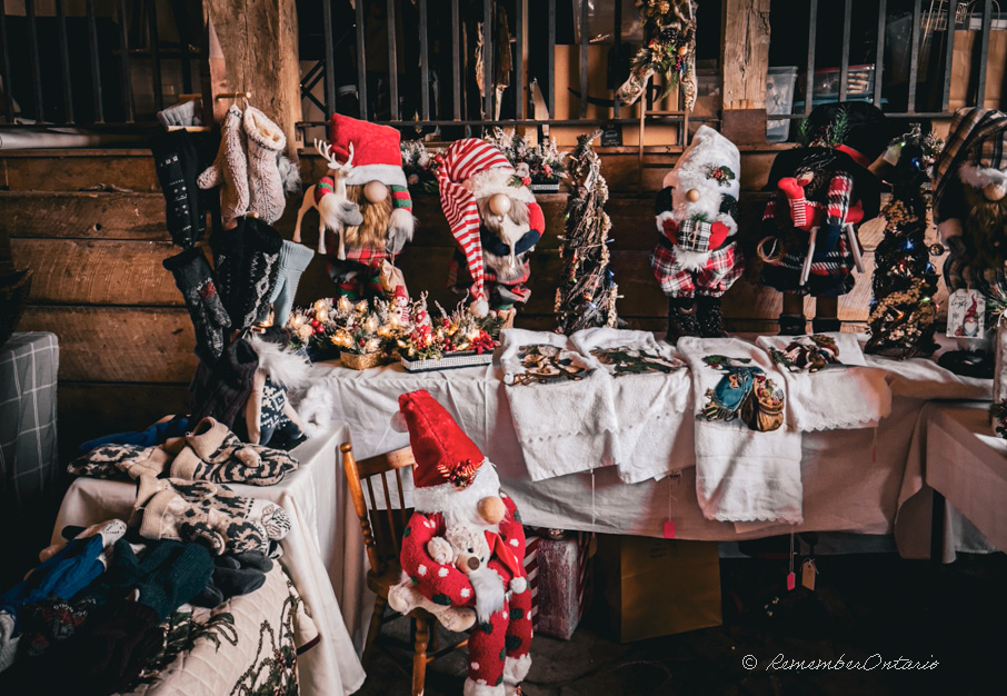 Embroidery cloths, knitted hats, mittens and scarves, and other handmade needlework decorated with Christmas accent were shown on table at the Christmas Market.